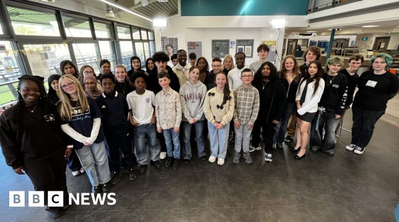 A group of children discussing social media restrictions in a classroom setting.