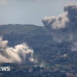 Rescue workers discussing operations in Lebanon after Israeli airstrikes.