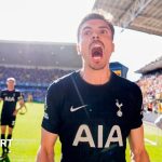 Tottenham players celebrating their Premier League win after a match.