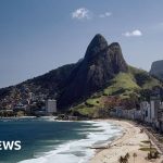 Tourists on hilltop looking concerned during police operation at Morro Dois Irmãos.