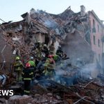 Emergency responders at a damaged site in Ukraine after the attack, showcasing community support.