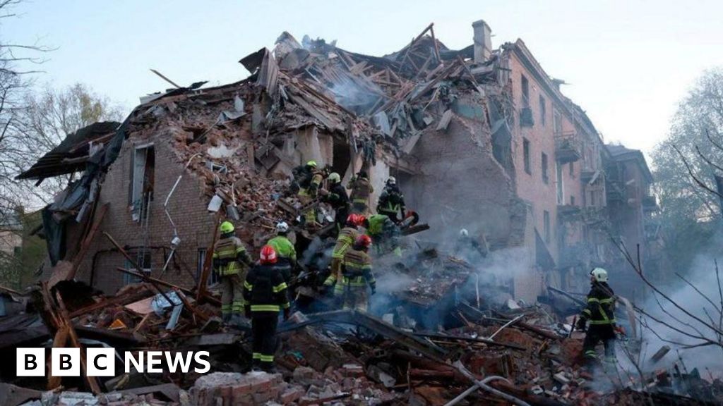 Emergency responders at a damaged site in Ukraine after the attack, showcasing community support.