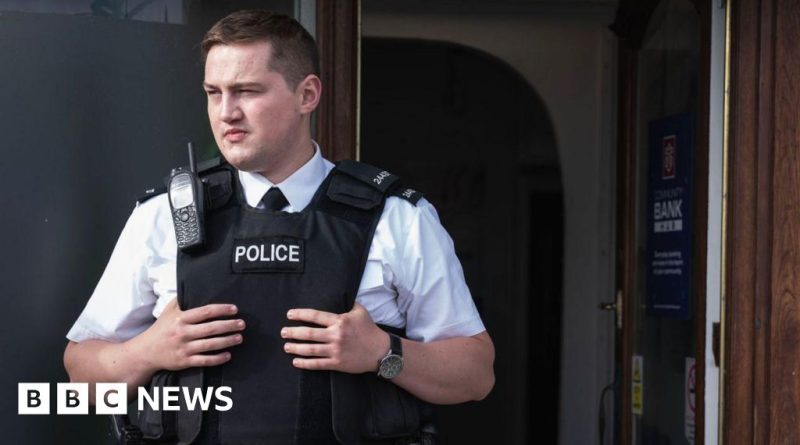 A memorial tribute for Finnian Garbutt's death with flowers and candles.