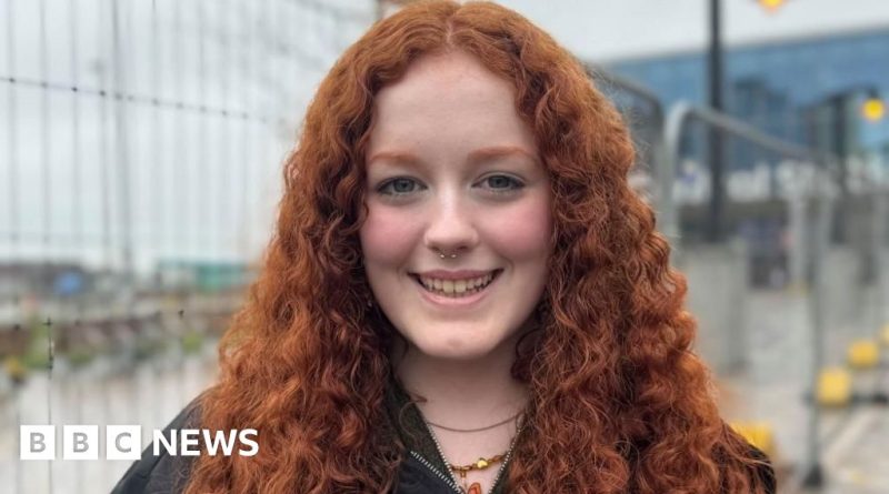 Commuters in professional attire at a bus station during Translink fare freeze.
