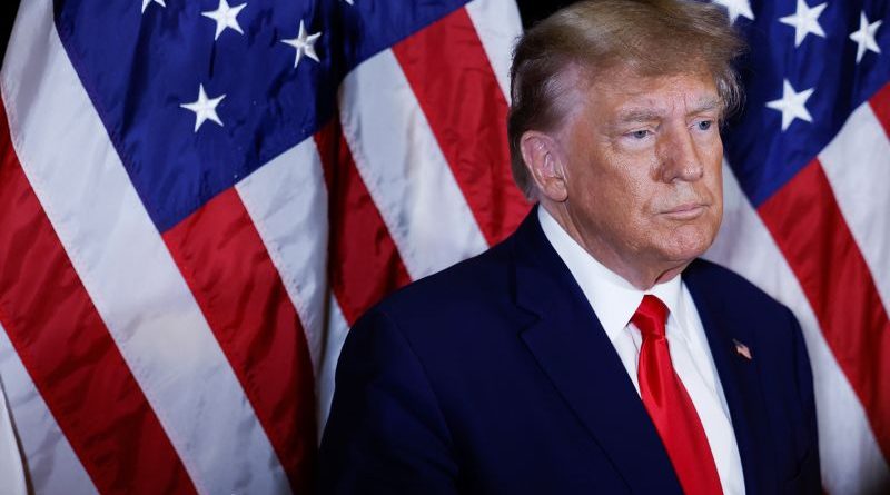 Trump felony charges being discussed outside a courthouse by professionals.