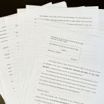 Lawyers discussing the Trump hush money payment case in an office.