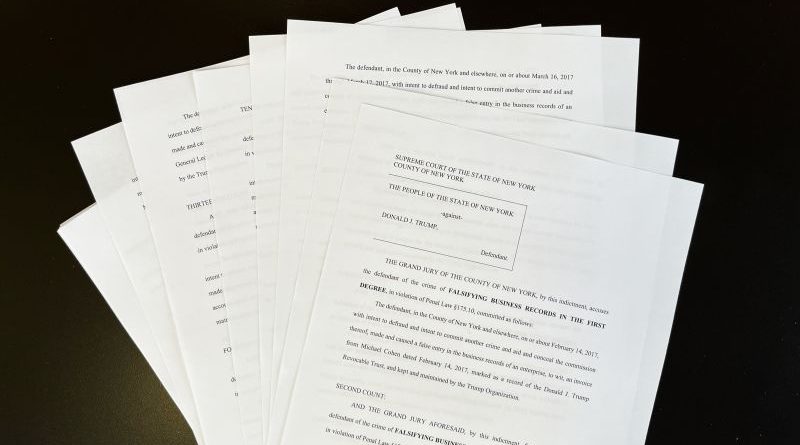 Lawyers discussing the Trump hush money payment case in an office.