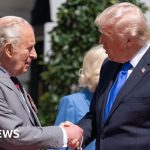 Business professionals discussing whisky tariffs removal in a formal meeting.