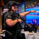 Professionals discussing Trump security challenges at a formal event.