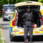 Community members discussing safety measures outside a synagogue after the synagogue attack.