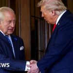 Diplomats discussing King's visit to strengthen US relations.