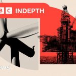 Professionals discussing UK energy transition challenges in an office setting.