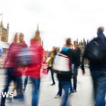 A business meeting discussing UK government borrowing and finances.