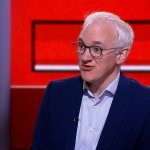 Group of professionals discussing UK health data sale concerns.