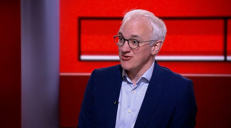 Group of professionals discussing UK health data sale concerns.