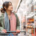 Professionals analyzing supply chain data in a modern office setting, focusing on UK supply chain disruptions.