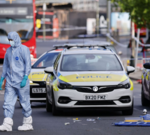 Professionals discussing UK terrorism threat level in an office setting.