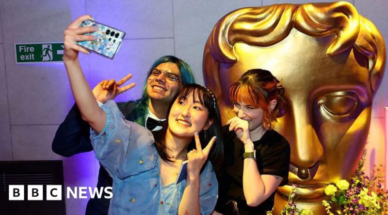 Professionals discussing the impact of video games at an awards event.