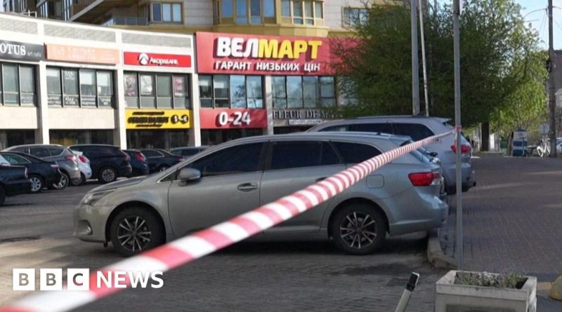 Police officers discussing a serious incident in Ukraine, reflecting accountability concerns.