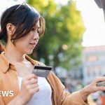 Professionals discussing UK interest rates in a modern office setting.