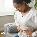 Professionals discussing bowel cancer symptoms and prevention in a modern office setting.