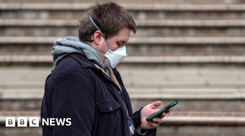 Diverse professionals discussing meningitis symptoms and spread in an office setting.