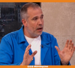 Doctor discussing testosterone effects with a patient in a clinic.