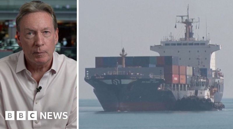 Group discussing US blockade of Iranian ports in a business setting.