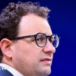 Group of professionals discussing AI technology at a meeting.