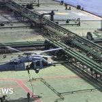 US Navy ship monitoring an Iranian oil shipment in tense waters.