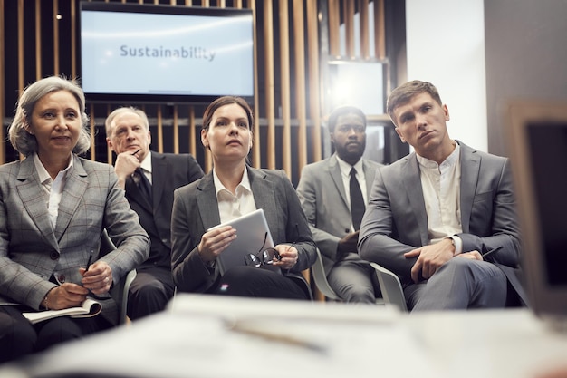 A meeting of diplomats discussing US Iran peace talks in a conference room.