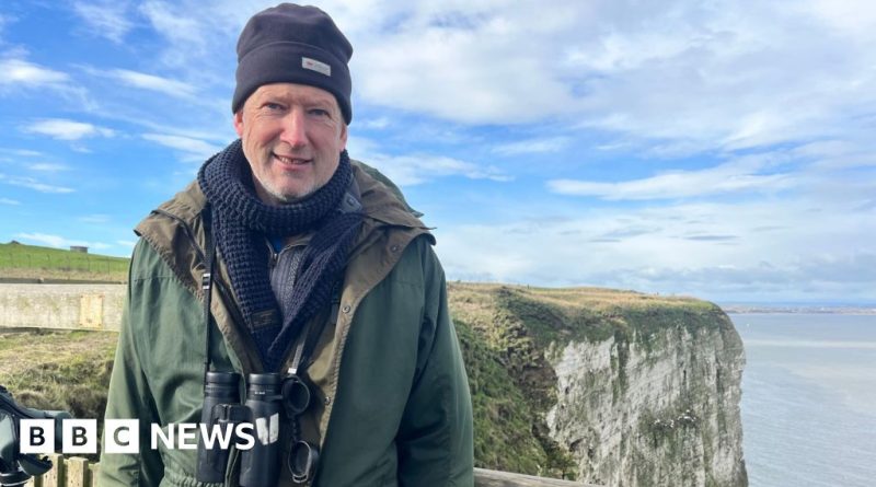 People observing birds at Bempton Cliffs, highlighting bird protection efforts.
