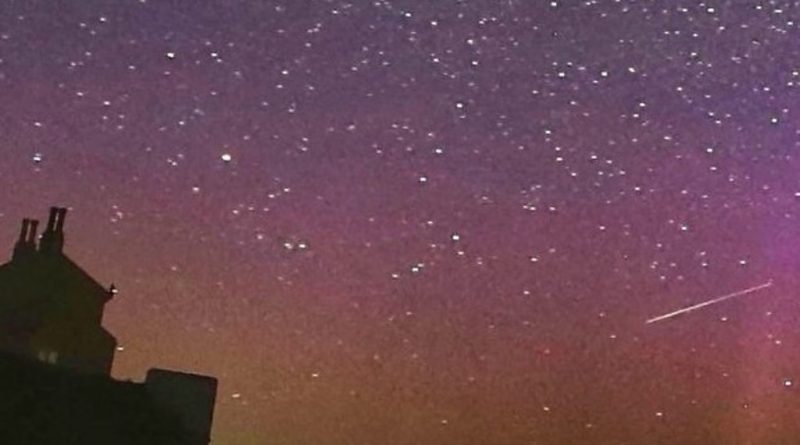 A family enjoying the Lyrid meteor shower while stargazing at night.