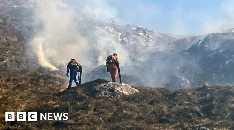 Firefighters assessing a wildfire in Scotland, highlighting the importance of safety during wildfire emergencies.