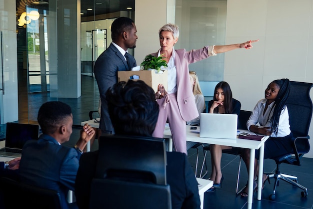 A group discussing wives' household responsibilities in a modern office.