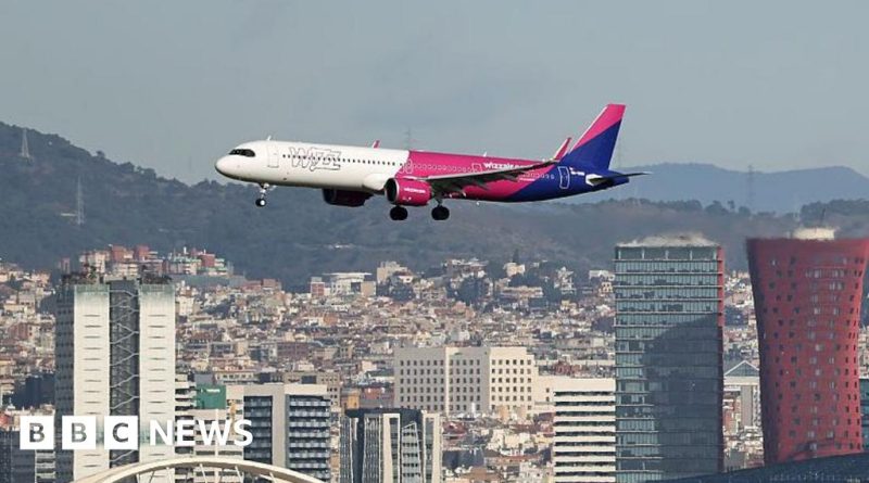 European flight prices discussed by Wizz Air CEO in busy airport terminal.