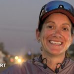 A woman running a marathon in India, honoring her father during her journey.