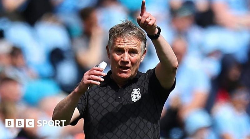 Wrexham football players preparing for a match to secure a play-off spot.
