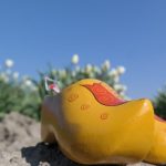 Yayoi Kusama yellow pumpkin sculpture on Naoshima Island with visitors.