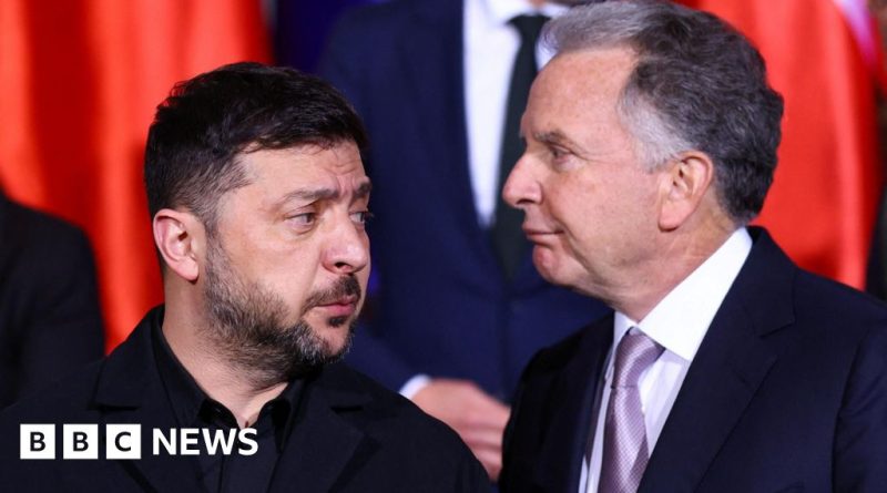 Diplomats discussing US envoy visits to Kyiv in a formal office setting.