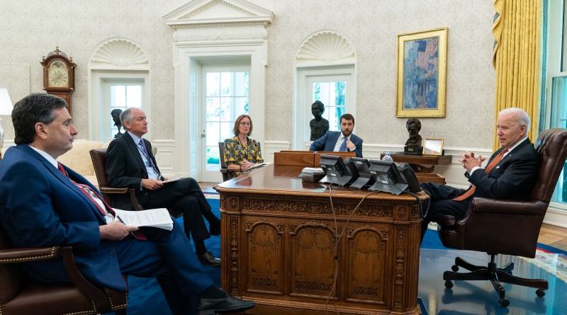 Diverse professionals discussing bipartisan legislative success in a modern office setting.