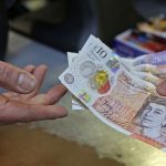 Business professionals discussing the British pound recovery in a meeting.