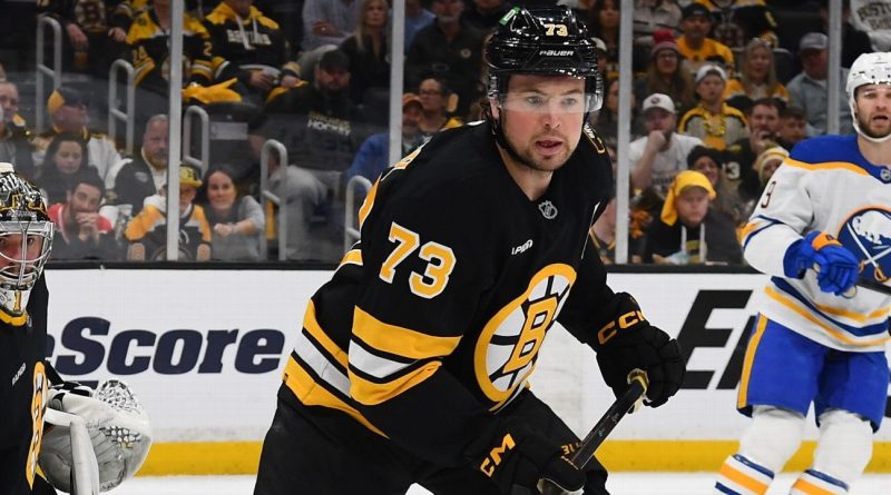 Charlie McAvoy ejection during a hockey game with tense players on ice.