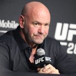 Group of professionals in business attire discussing Dana White domestic incident.