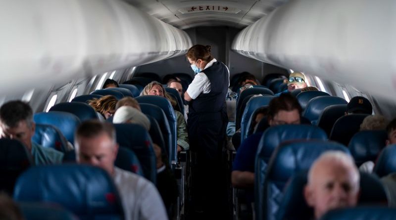 Flight attendants in a busy airport promoting better flight attendant rest time.