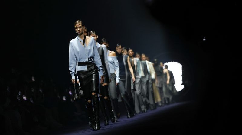 Diverse designers presenting their collections at a fashion runway show highlighting a backward trend in fashion.