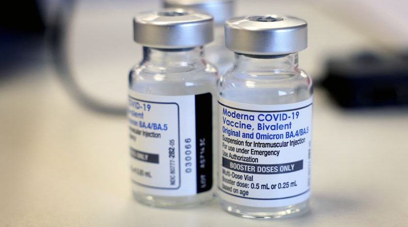 Group of professionals discussing extra bivalent vaccine doses for public health.