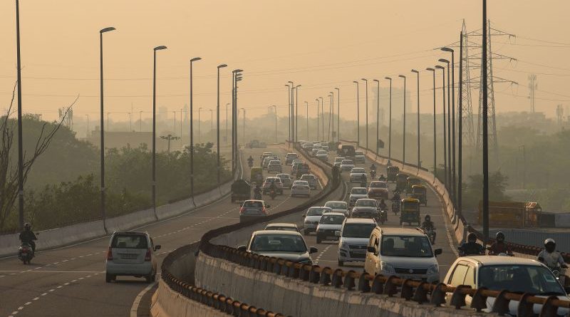 Professionals discussing global air quality data in a modern office.