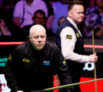 Higgins and Murphy in a tense snooker match at the Crucible Theatre.