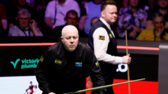 Higgins and Murphy in a tense snooker match at the Crucible Theatre.